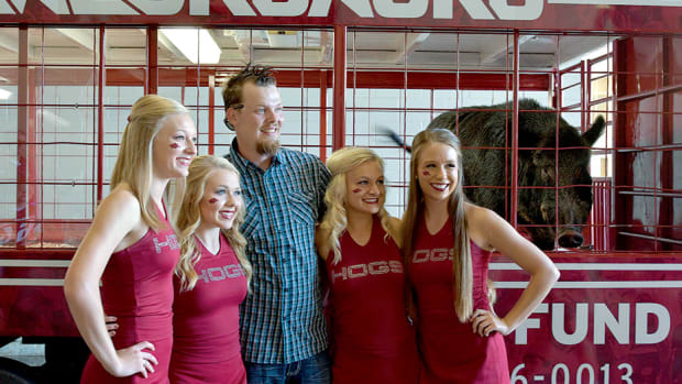 Arkansas Razorbacks cheerleaders take selfies with Tusk IV, the Russian boar mascot prior to the game against the Texas State Bobcats at Donald W. Reynolds Razorback Stadium.